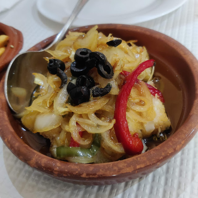 Fried Cod in Onions Olives and Paprika with Potato Chips
