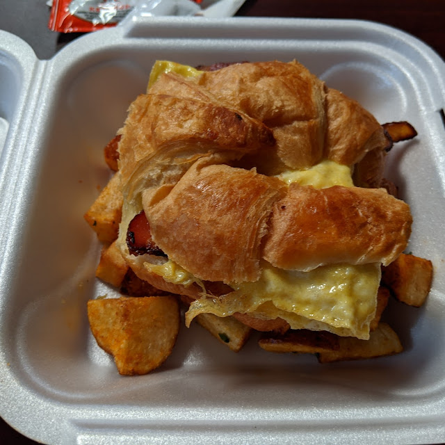 The Morning Special Bacon Egg and Cheese Croissant with Home Fries