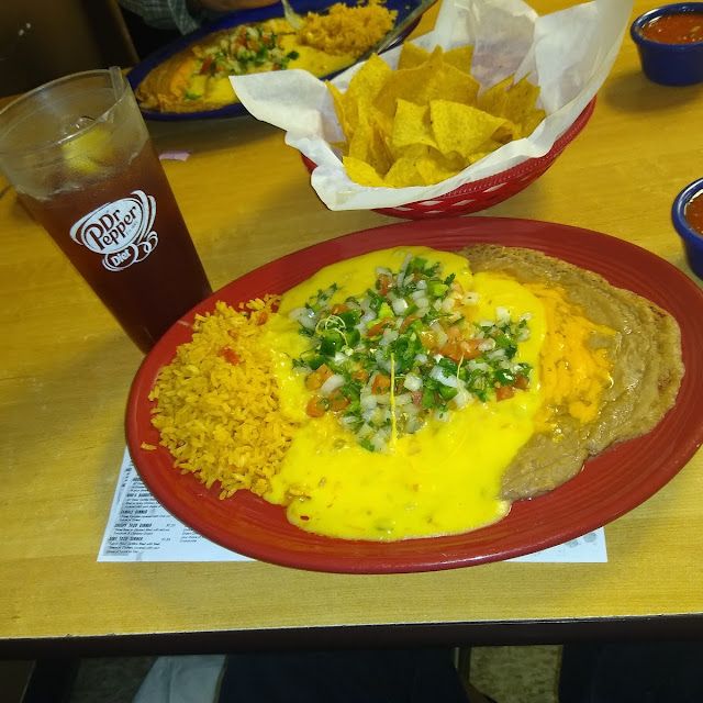 Chicken Enchilada Plate Top with the Pico De Gallo and Yellow Queso with Rice and Beans