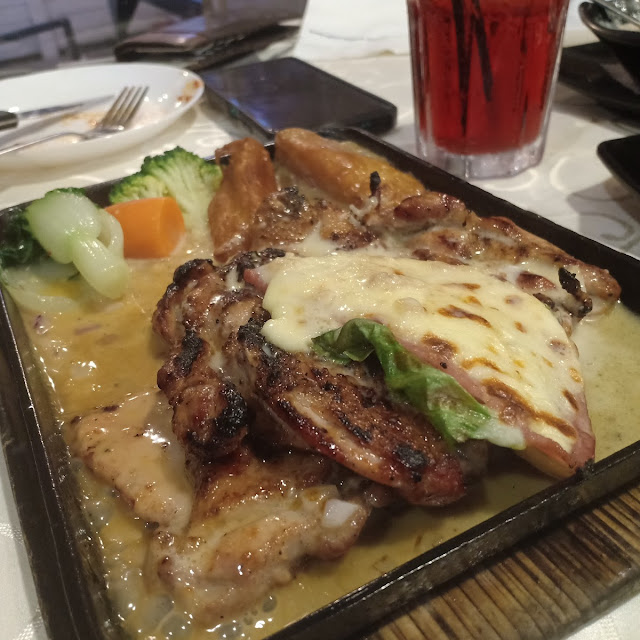 Sizzling Grilled Chicken Topped with Ham & Cheese Served with Butter Cream Sauces