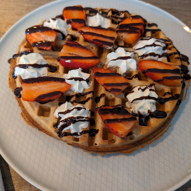 Waffle with Whipped Cream Strawberries and Chocolate Syrop