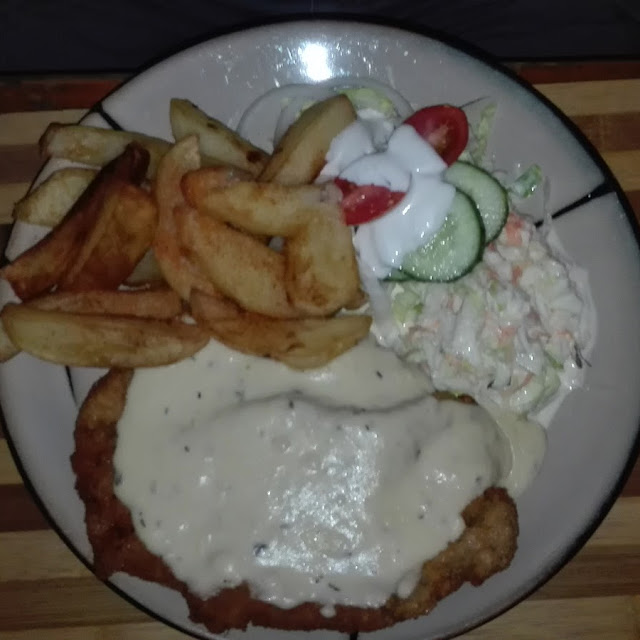 Pork Schnitzel with Wedges and Salad with Mushroom Sause
