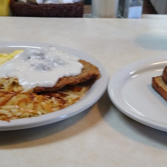 Country Fried Steak and Eggs with Sausage Gravy and Hash Browns