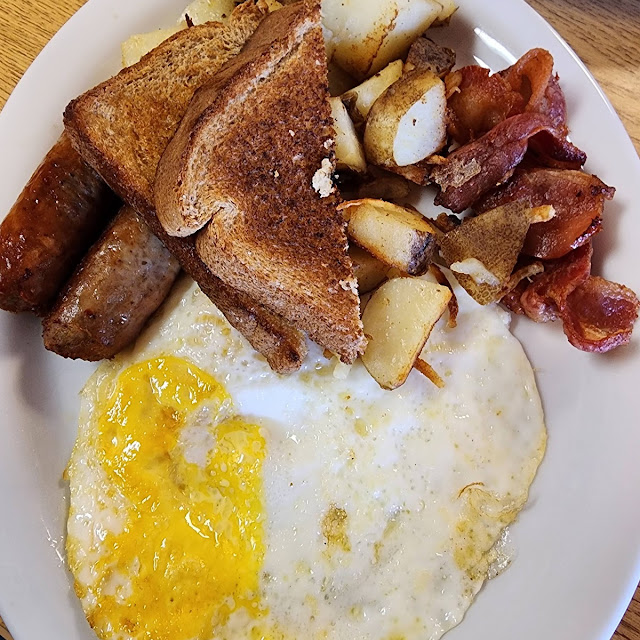 Corn Beef Hash with 2 Eggs over Easy and Hash Browns with Sourdough Toast