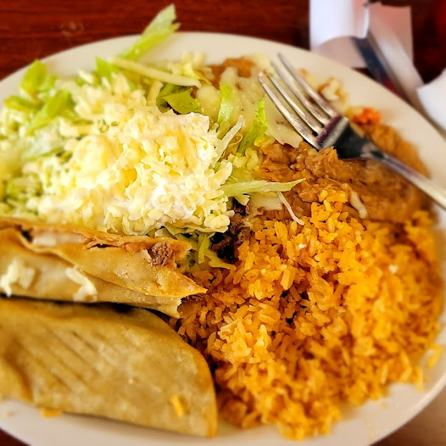 Taquitos Mexicanos with Refried Beans Lettuce and Sour Cream